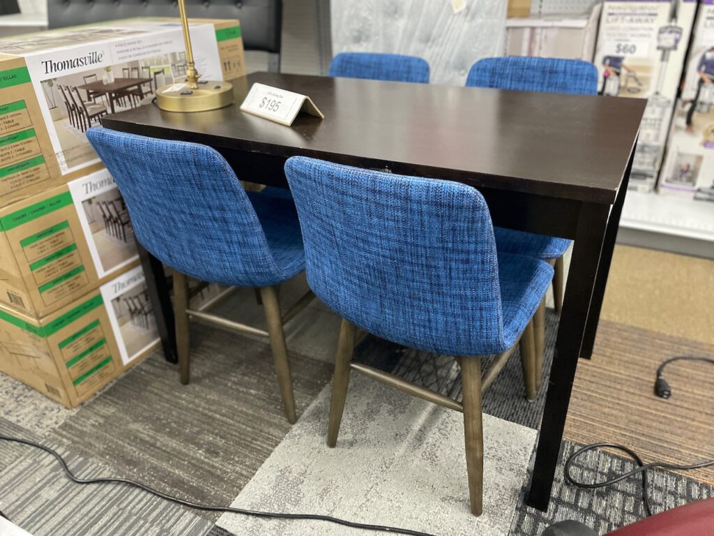 Dark wooden table with 4 blue fabric covered chairs