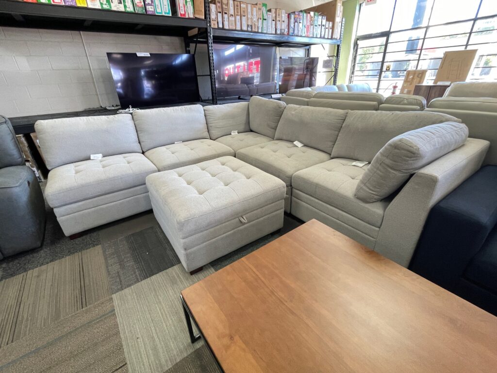 Off white fabric sectional with storage/ottoman