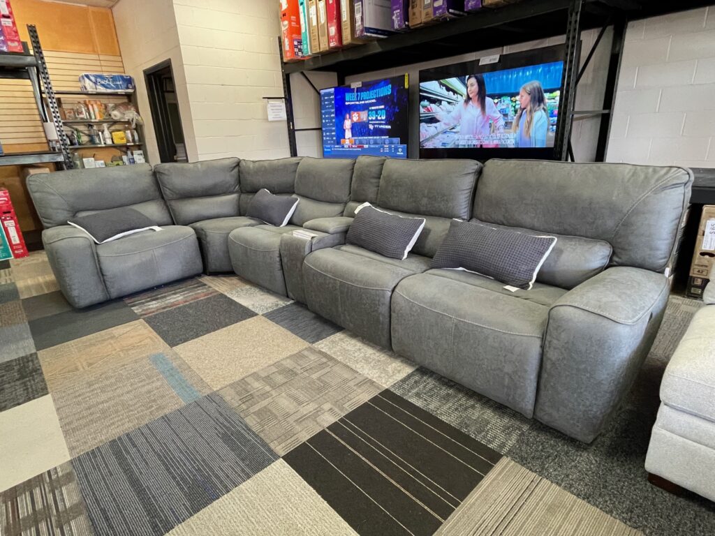 Gray leather sectional with matching pillows